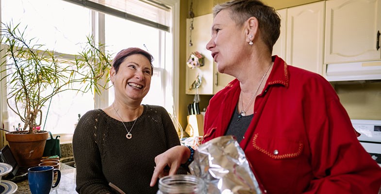 two woman chatting in kitchen