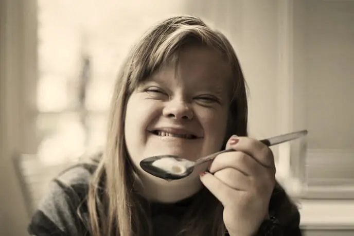woman smiling with spoon