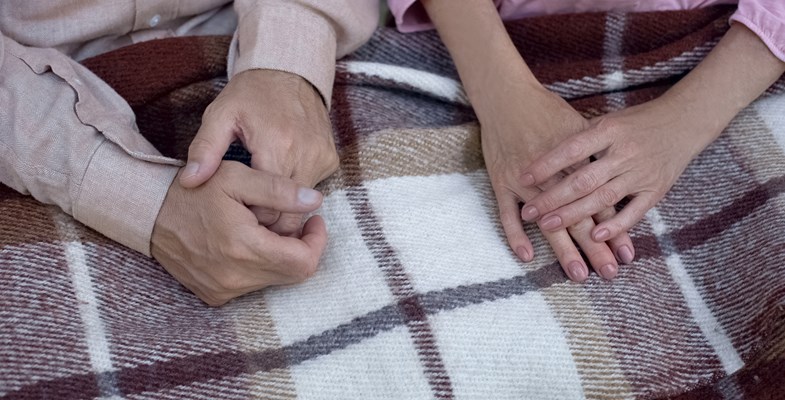 two people sharing a blanket