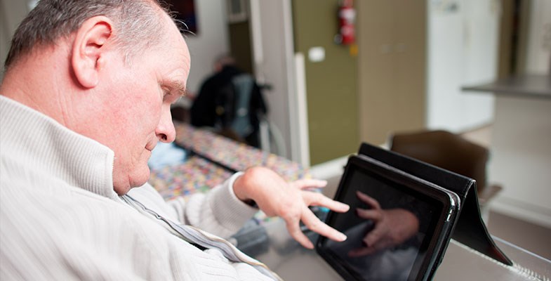 man with disability using tablet